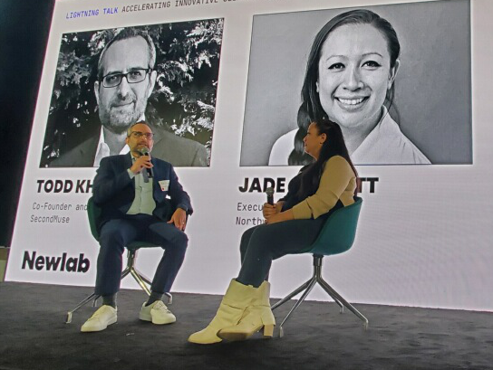 2 people having a discussion on a stage